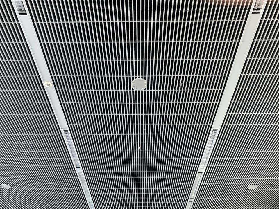 A long slatted metal ceiling vent